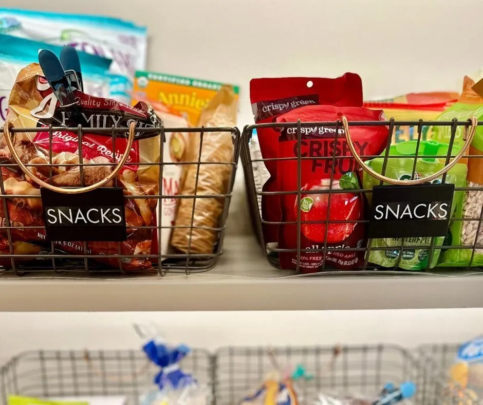 Wire baskets of snacks with black Snacks labels