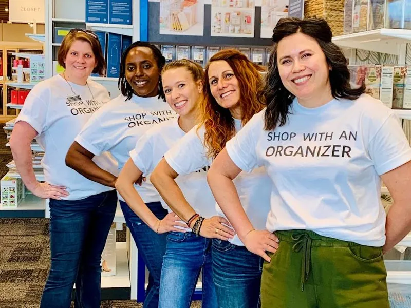 Five Joyful Spaces organizers smiling in matching Shop With an Organizer T-shirts